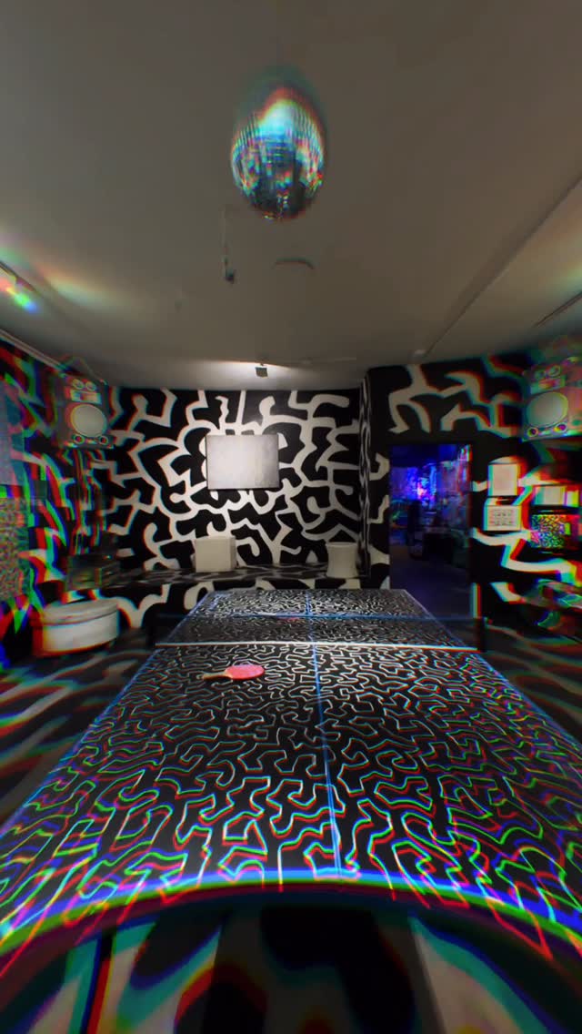 Immersive black and white line room with ping pong table